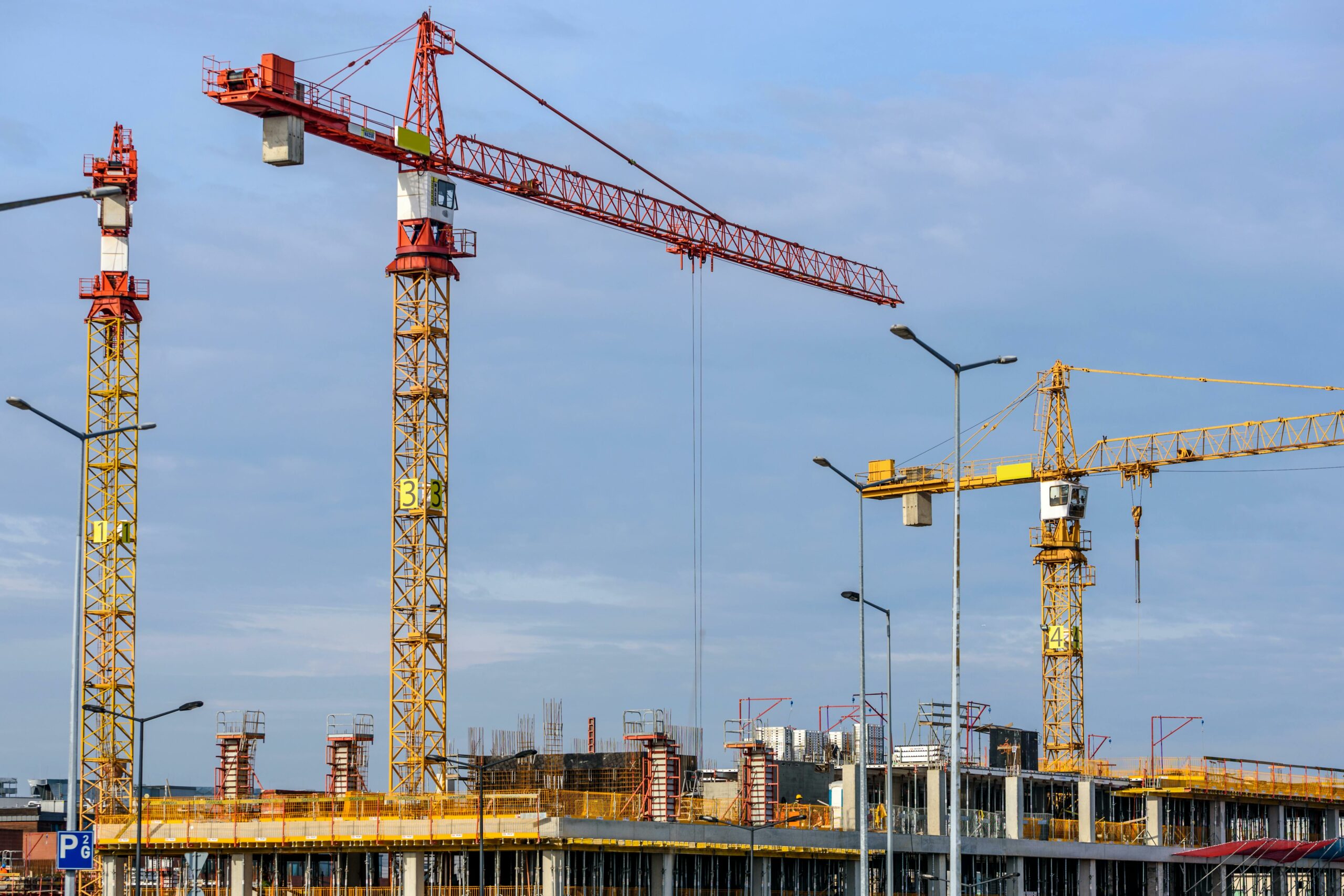 Several cranes towering over a construction site